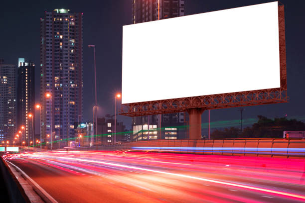 istock blank billboard on light trails of night street 665698782