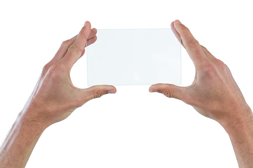 Hands holding futuristic digital tablet against white background
