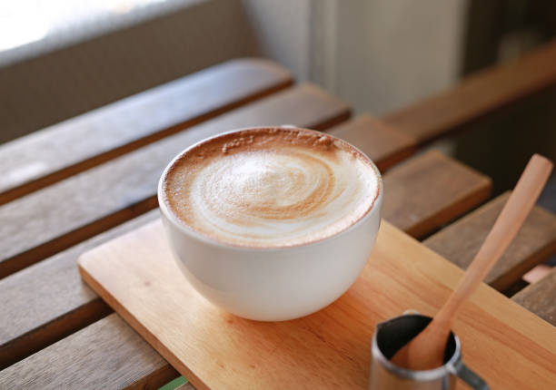 istock Hot latte coffee on wooden table. 665708644