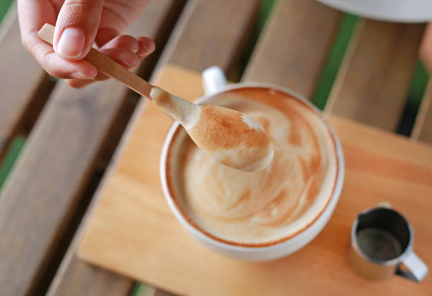 istock Hot latte coffee on wooden table. 665709094