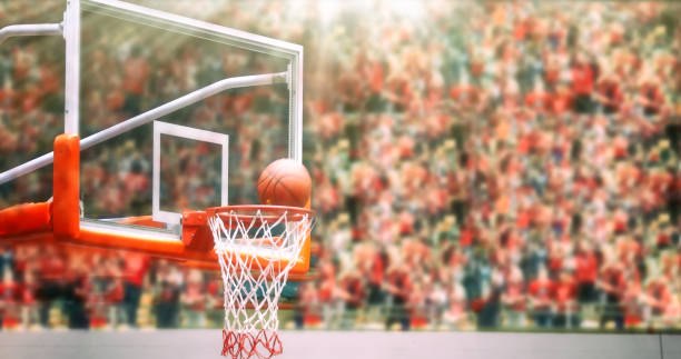 istock Basketball going through net and scoring during match ,Blurry and soft focus 665718256