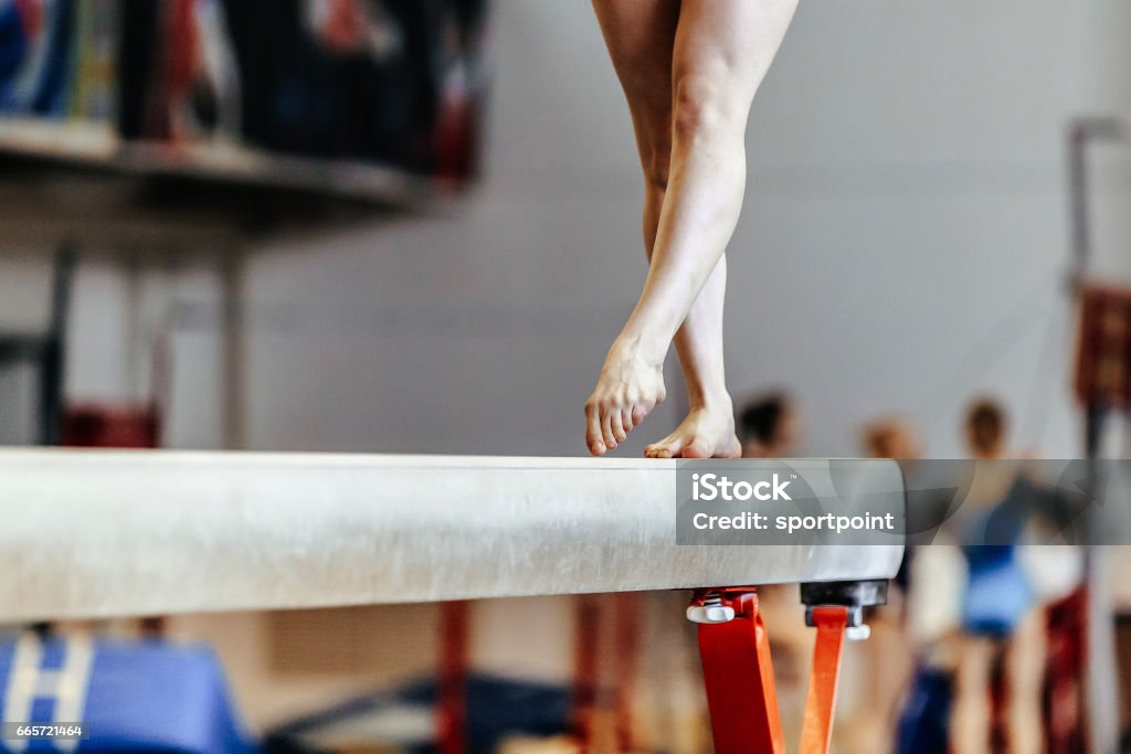 feet woman gymnast exercises on balance beam competition in artistic gymnastics Gymnastics Stock Photo