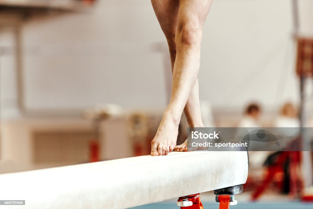 closeup legs women gymnasts exercises on balance beam Balance Beam Stock Photo