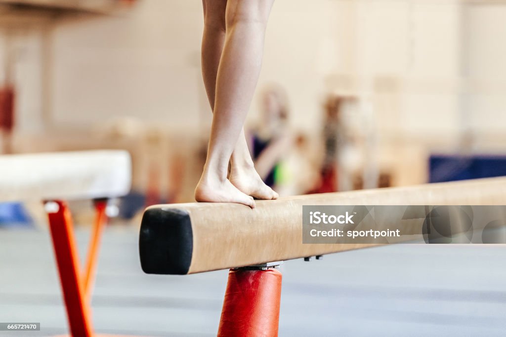 legs women gymnasts exercises on balance beam Gymnastics Stock Photo