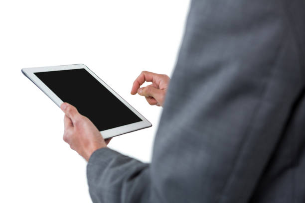 istock Mid section of businessman using digital tablet 665725208