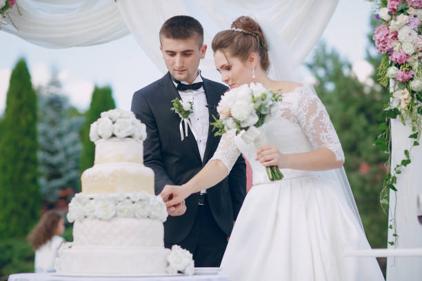 istock couple with wedding cake 665725260