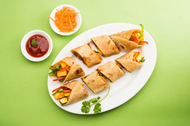 Photo of Save
Download Preview
Indian popular snack food called Vegetable spring rolls or veg roll or veg franky made using paneer or cottage cheese and vegetables wrapped inside paratha/chapati/roti with tomato ketchup.