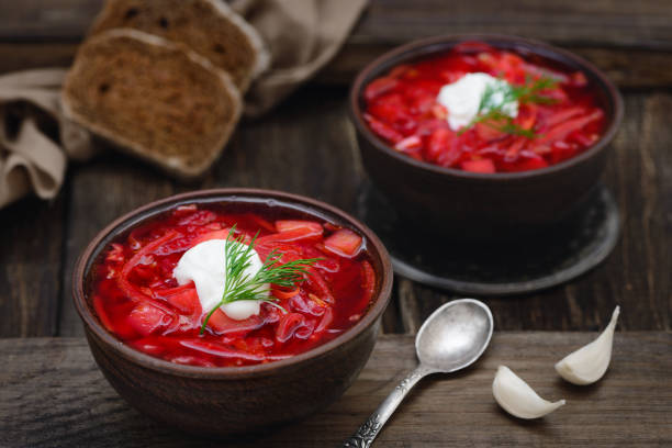 Vegan borscht in bowls on an old wooden background stock photo