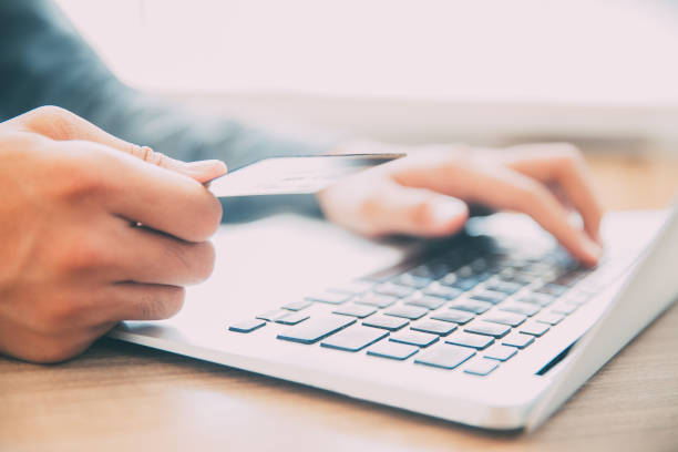 istock Hands holding credit card and typing on laptop 665736776