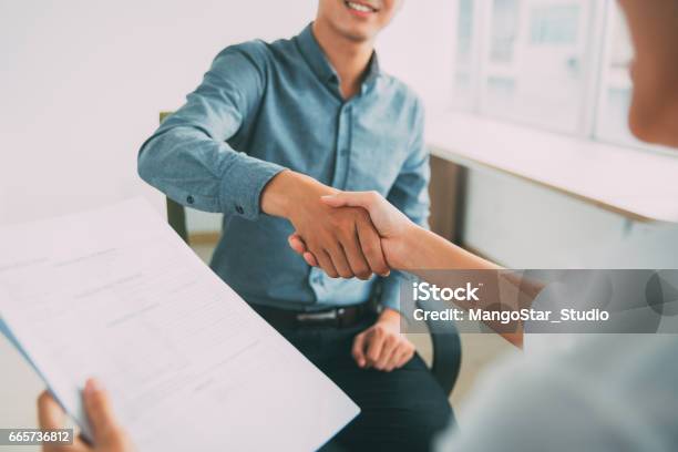 Smiling Asian Businessman Shaking Partners Hand Stock Photo - Download Image Now - Job Interview, Handshake, Casual Clothing