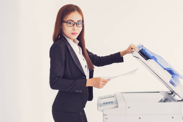 istock Content Asian Business Woman Using Copier Machine 665736912