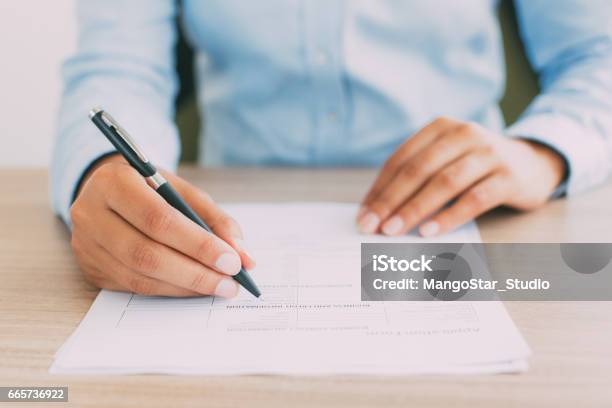 Cropped View Of Person Completing Application Form Stock Photo - Download Image Now - Document, Application Form, Checklist