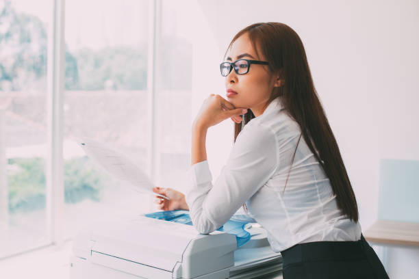 istock Thoughtful Business Lady with Document at Window 665737024