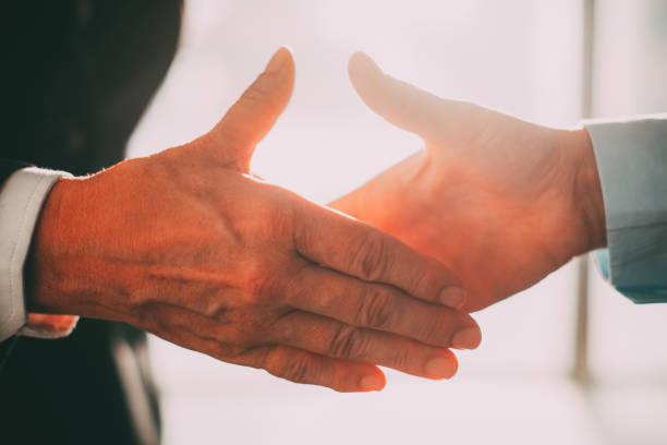 istock Business partners reaching hands to shake it_tone 665737030