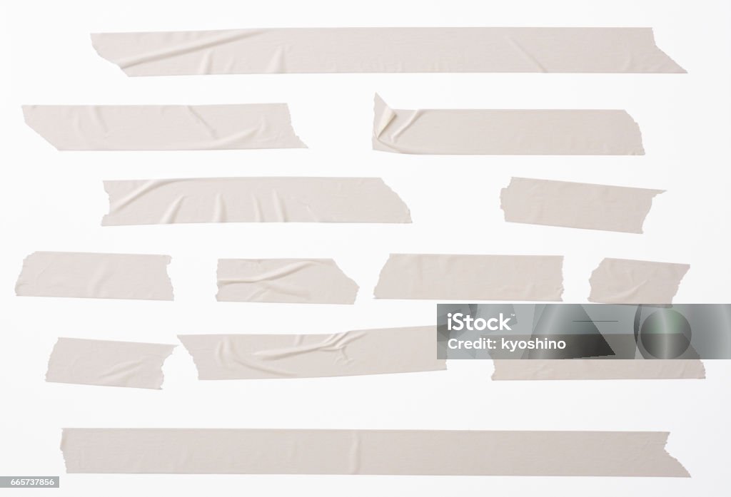 Isolated shot of many torn masking tape on white background Lots of torn masking tape, isolated on white with clipping path. Adhesive Tape Stock Photo