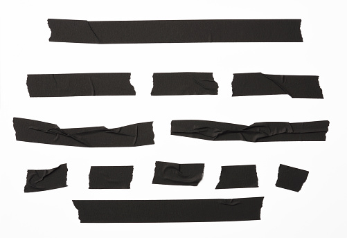 Isolated shot of torn black adhesive tape on white background
