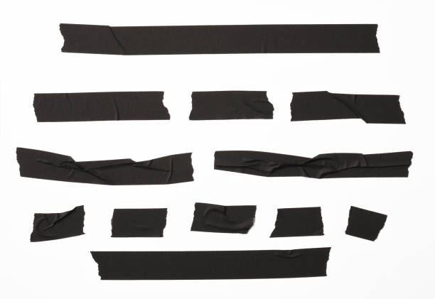 isolated shot of torn black adhesive tape on white background - adhesive tape imagens e fotografias de stock