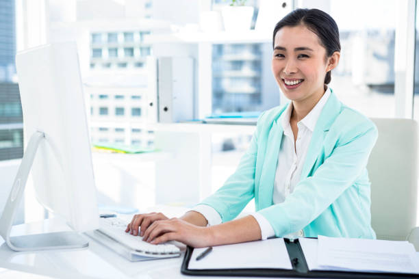 istock Smiling businesswoman with notes at desk 665738370