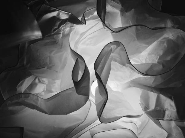 Fabric Texture Background, Close Up of  Transparent Crumpled Black Curtain with Light.