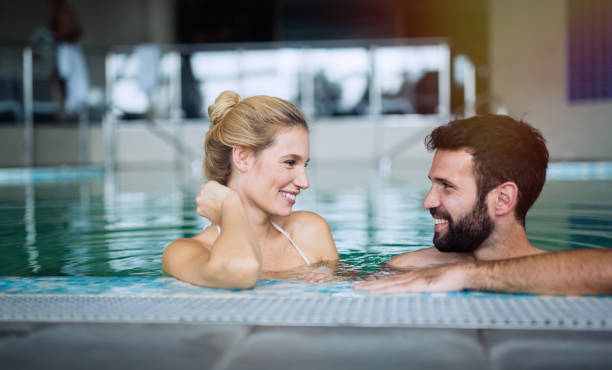 istock Romantic couple enjoying thermal bath spa and wellness center 665747148
