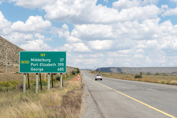 Distance sign on the N9 road Noupoort: A distance sign on the N9 road near Noupoort, a small railway town in the Northern Cape Province george south africa stock pictures, royalty-free photos & images