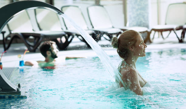 istock Woman enjoying hydrotherapy and water stream in spa pool 665747746