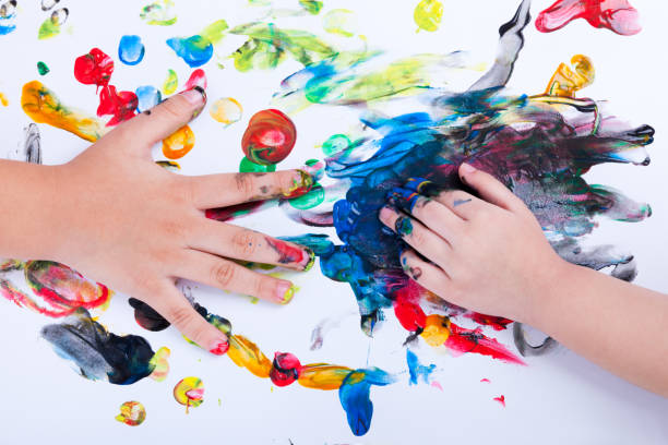 istock Children hands doing finger painting with various colors 665751032