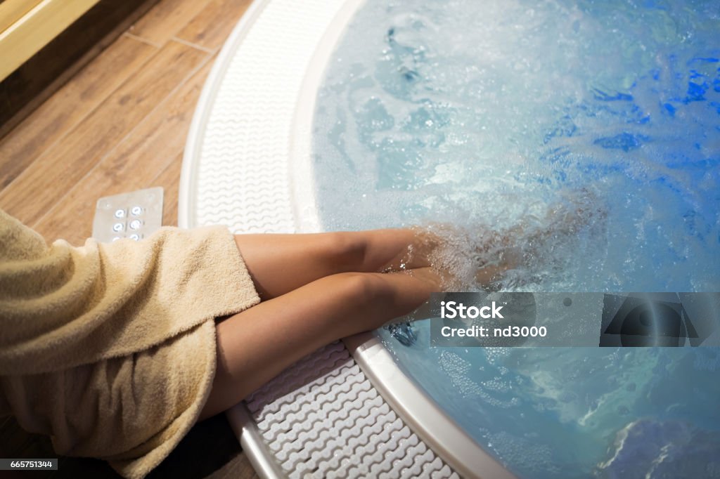 Woman enjoying hot tub relaxation at spa resort Activity Stock Photo