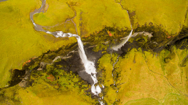 istock Scenic view of waterfall and mountain landscape 665757350
