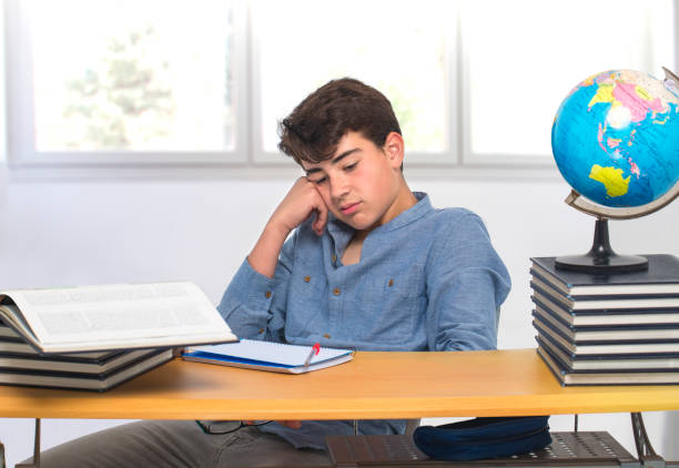 istock Student sitting at the desk bored in the classroom 665757676