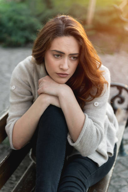 istock Sad girl sitting on a bench 665757886