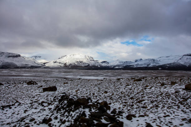 Scenic view of snow covered mountains. Idyllic view of Icelandic landscape during winter. Beautiful view of nature against cloudy sky in Iceland.