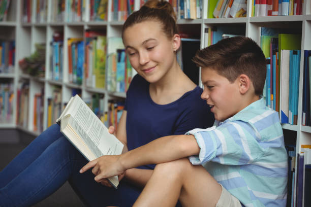 istock School kids reading books in library at school 665760346