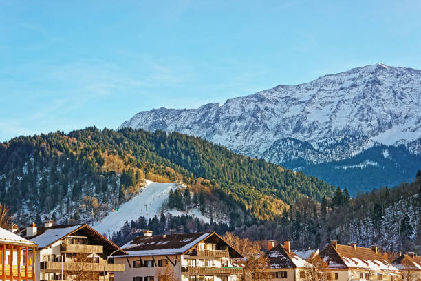 istock Alpine mountains and chalets in winter Garmisch Partenkirchen 665760702
