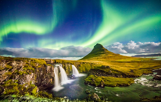 Scenic view of aurora over Kirkjufell and waterfall. Idyllic view of Northern Lights in Iceland. Beautiful view of nature at night.