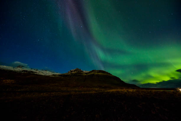 istock Scenic view of Northern Lights over mountain 665761062