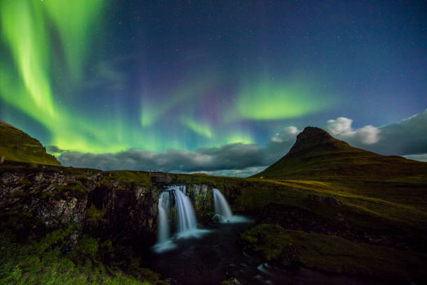 istock Scenic view of Aurora Borealis over waterfall 665761130