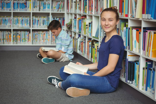 istock School kids reading books in library at school 665761382