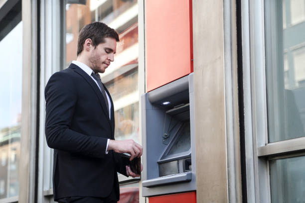 istock Businessman at an ATM 665770916