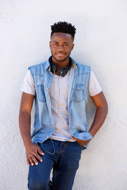 istock happy man standing with headphones against white background 665771496