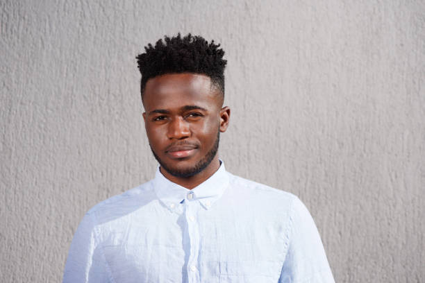 istock handsome young african man with beard standing looking serious 665771522