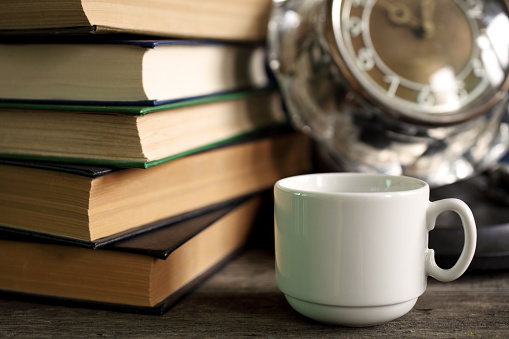 Books, cup and clock