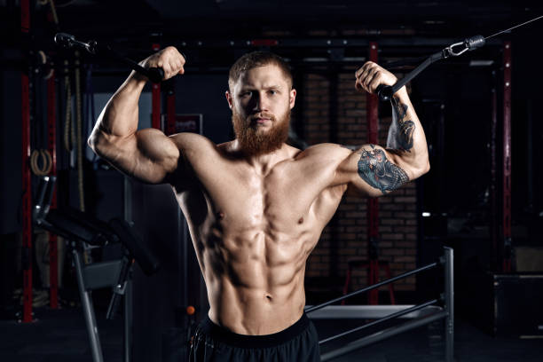 istock Young athlete doing exercises in the gym. 665771784