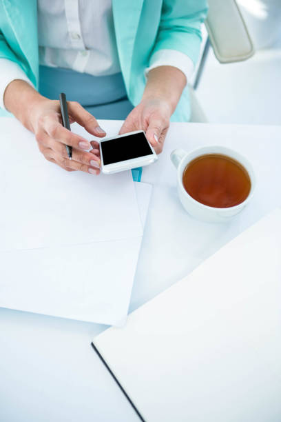 istock Businesswoman using her smart phone 665772328