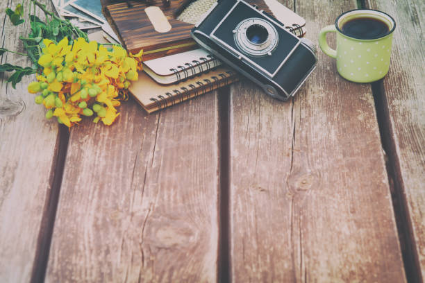 istock Image of notebooks next to vintage photo camera 665772608