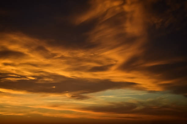 istock Dark moody sky with golden clouds during the sunrise 665775392
