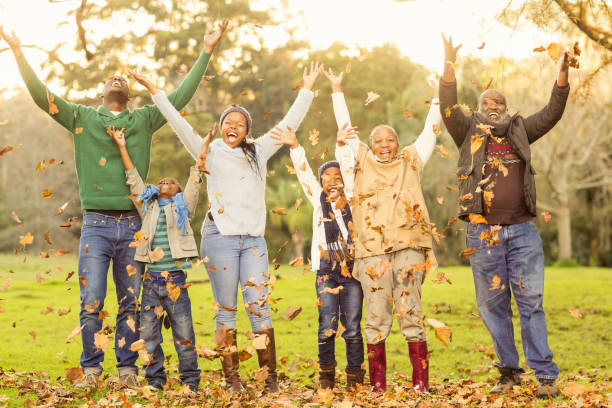 istock Happy family throwing leaves around 665775462