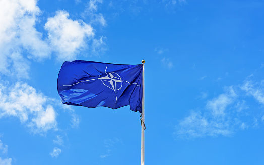 Vilnius, Lithuania - September 3, 2015: Flag of NATO waving in the wind