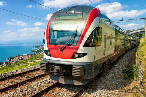 Train near Vineyard Terraces of Lavaux at Lake Geneva Alps