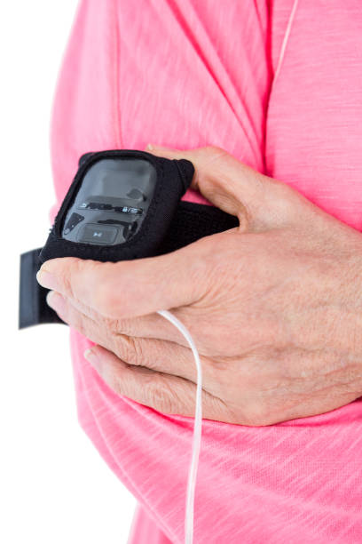 istock Woman holding mp3 player on armband 665785218